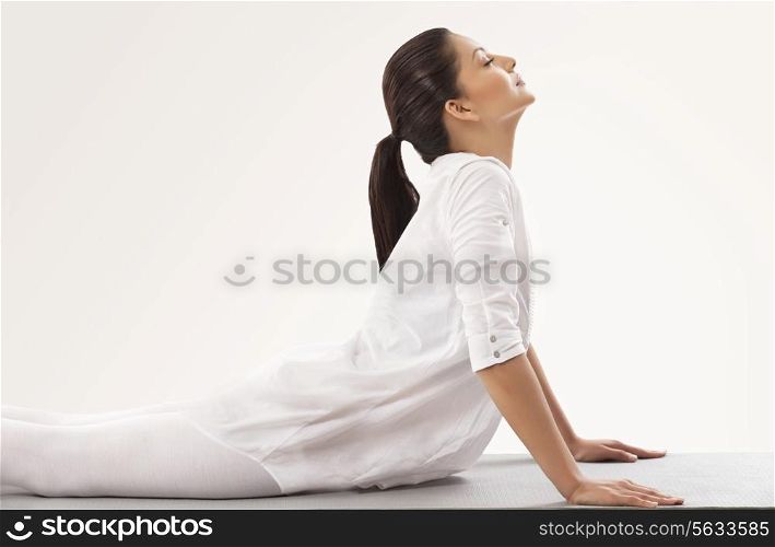 Young woman in upward facing dog position
