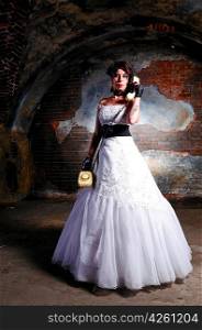 young woman in wedding dress at abandoned place