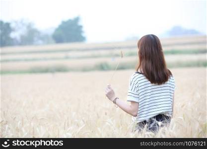 Young woman in wheat