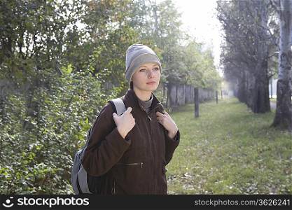 Young woman in winter clothing at park