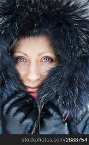 Young woman in winter fur hood.