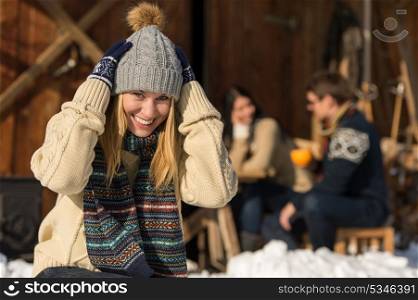 Young woman in winter hat spend time in snow cottage