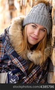 Young woman in winter jacket cover blanket portrait countryside