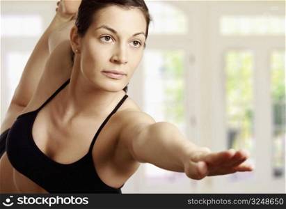 Young woman is doing an expert yoga exercise.