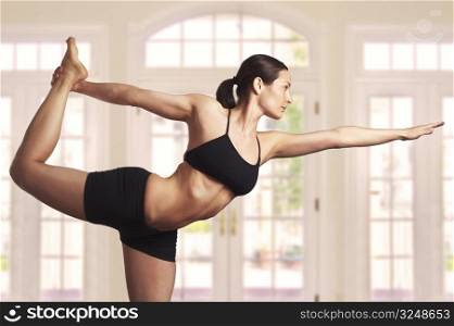Young woman is doing an expert yoga exercise.