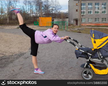 young woman is engaged in aerobics in a stadium combining a walk with baby