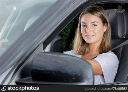young woman is happy in the car
