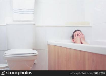 Young woman is in the bathtub having a bath