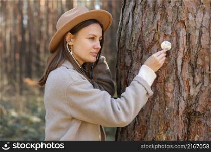 young woman is listening and care of a tree with stethoscope,dream job,female are a doctor,checking healthy green trees in park,love nature,protect environment,ecology concept.. young woman is listening and care of a tree with stethoscope,dream job,female are a doctor,checking healthy green trees in park,love nature,protect environment,ecology concept