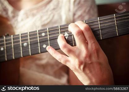 Young woman is playing guitar
