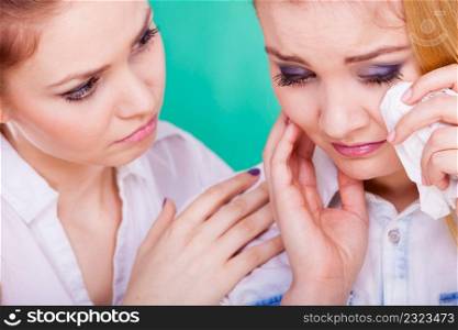 Young woman is sad crying and being consoled by friend. Girl comforting her sister. Mental problems depression and fatigue.. Sad woman crying and being consoled by friend.