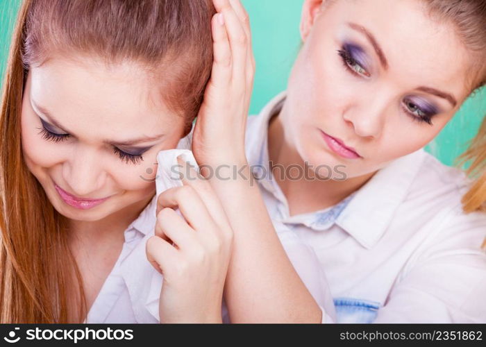Young woman is sad crying and being consoled by friend. Girl comforting her sister. Mental problems depression and fatigue.. Sad woman crying and being consoled by friend.