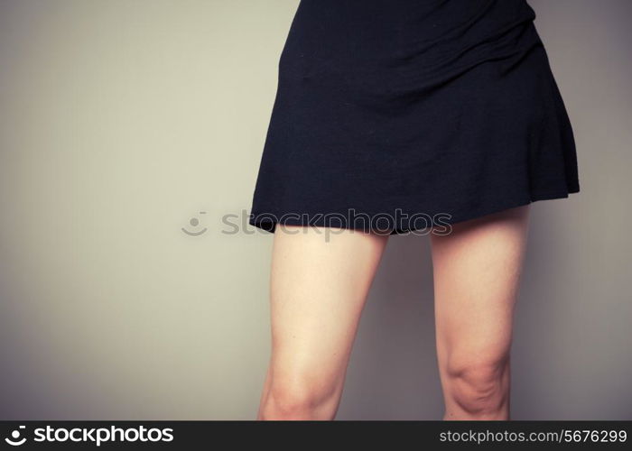 Young woman is standing in a black dress