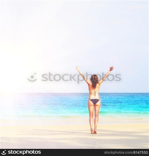 young woman is standing on beach. woman on beach