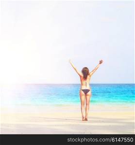 young woman is standing on beach. woman on beach