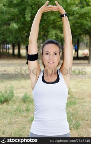 young woman is streching arms