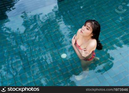 young woman is swimming in a cold plunge pool