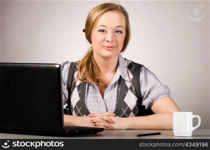 young woman is working on laptop at office