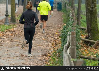 Young woman jogging in park in autumn. Health and fitness