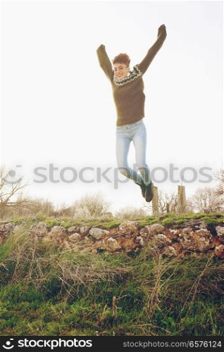 Young woman jumping outdoors