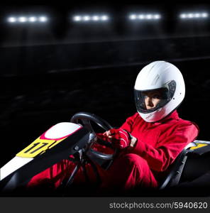 Young woman karting racer at stadium