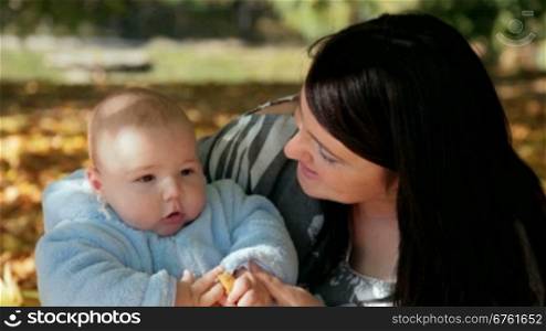 young woman kissing her 6 month old son
