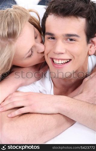 Young woman kissing her boyfriend