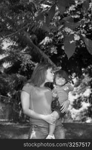 Young woman kissing her daughter