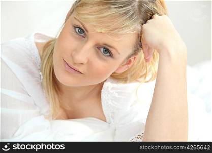 Young woman laid on a bed