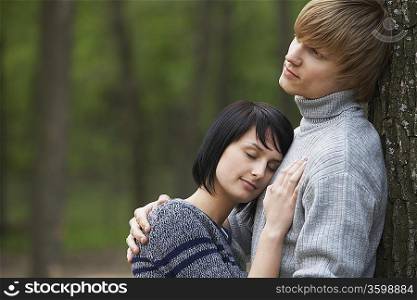 Young Woman Laying Head on Chest of Young Man