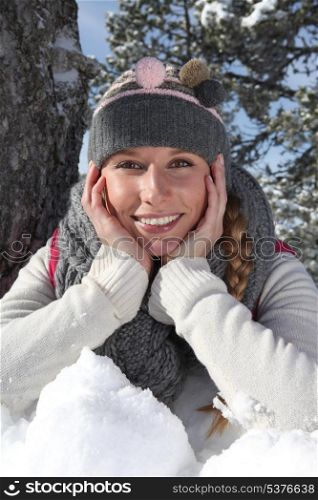 Young woman laying in snow