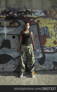 Young woman leaning against a wall