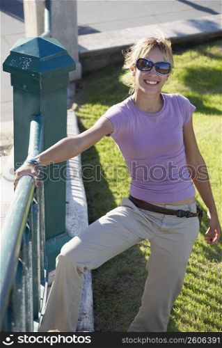 Young woman leaning on railing