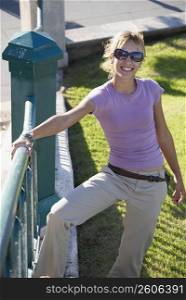 Young woman leaning on railing