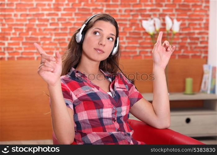 young woman listening music at home