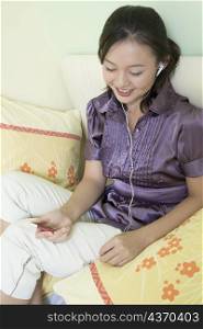 Young woman listening to music and smiling