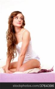 Young woman long curly hair relaxing on her bed at morning white background