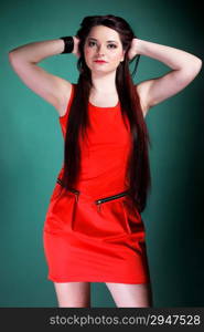 young woman long hair red dress on green background fashion photo