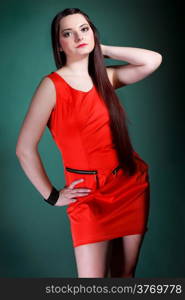 young woman long hair red dress on green background fashion photo