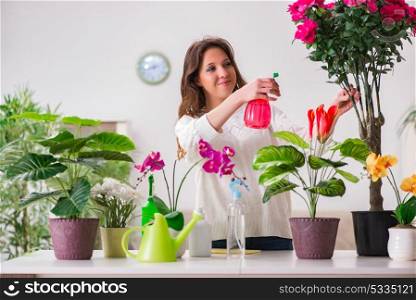 Young woman looking after plants at home