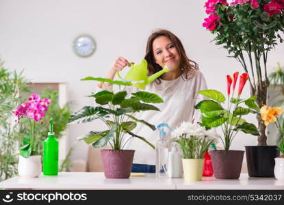 Young woman looking after plants at home