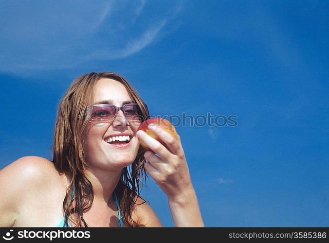 Young Woman Looking at Apple