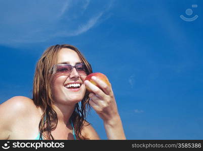 Young Woman Looking at Apple