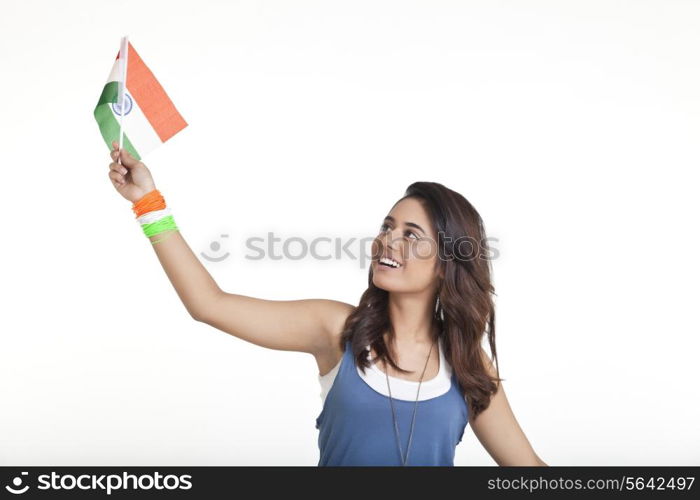 Young woman looking at Indian flag over white background