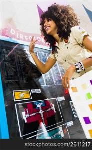 Young woman looking at mall directory