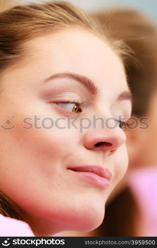 young woman looking at mirror in bathroom. Young woman looking at mirror in bathroom. Hygiene. Skincare spa treatment.