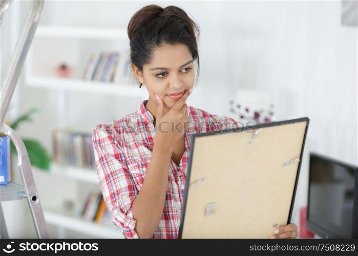 young woman looking at painting