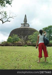 Young woman looking at stupa back view