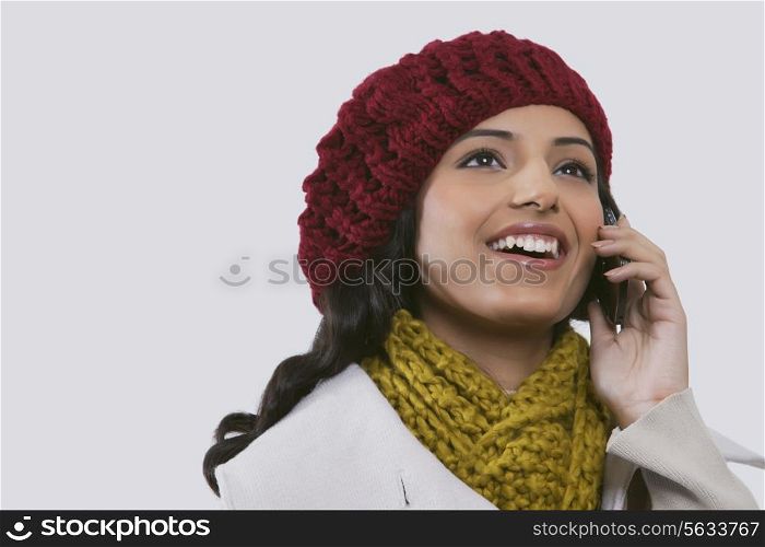 Young woman looking away while talking on cell phone