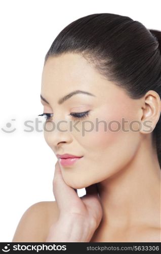 Young woman looking down over white background